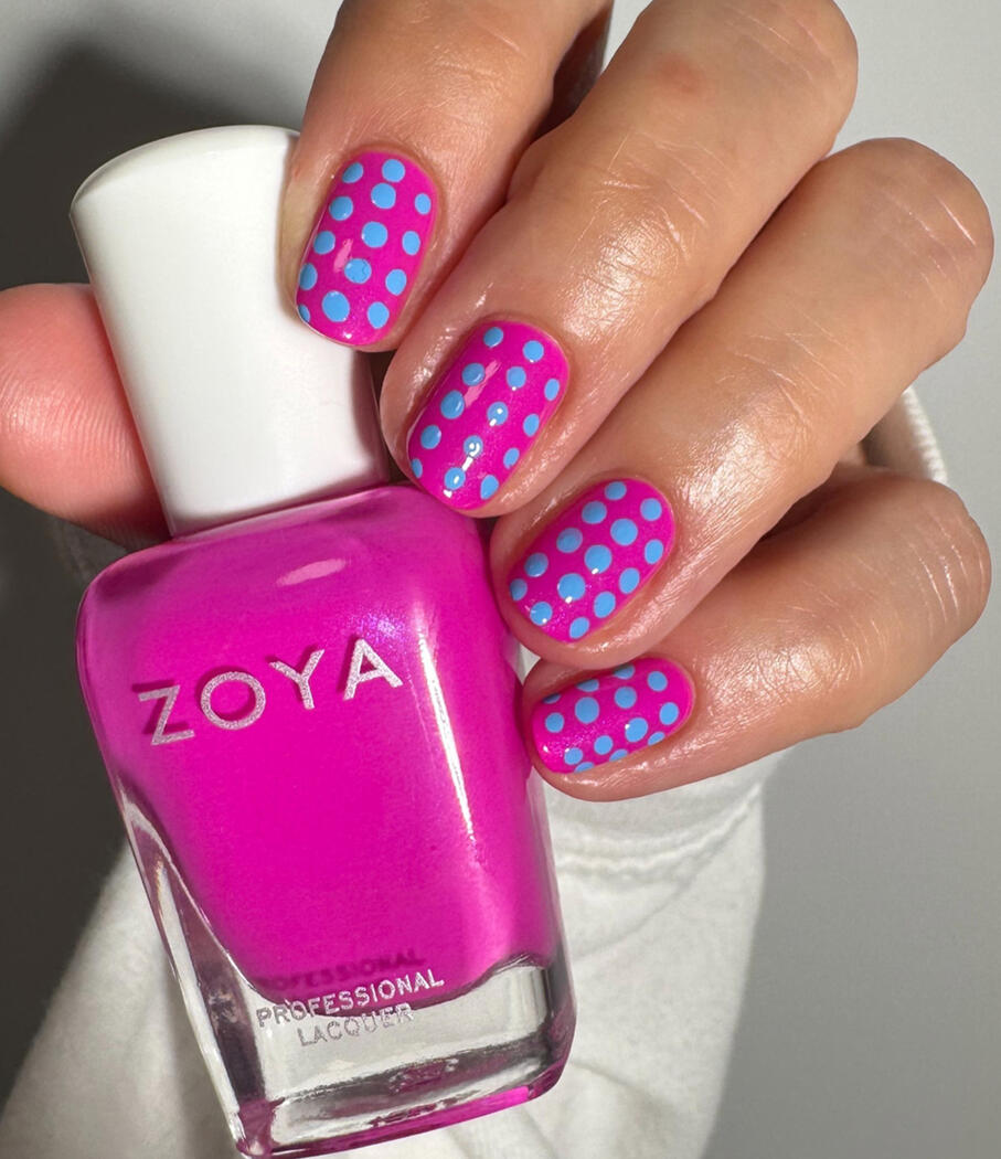 Trendy polka dot design, Zoya Summer 2025, on short natural nails in daylight.